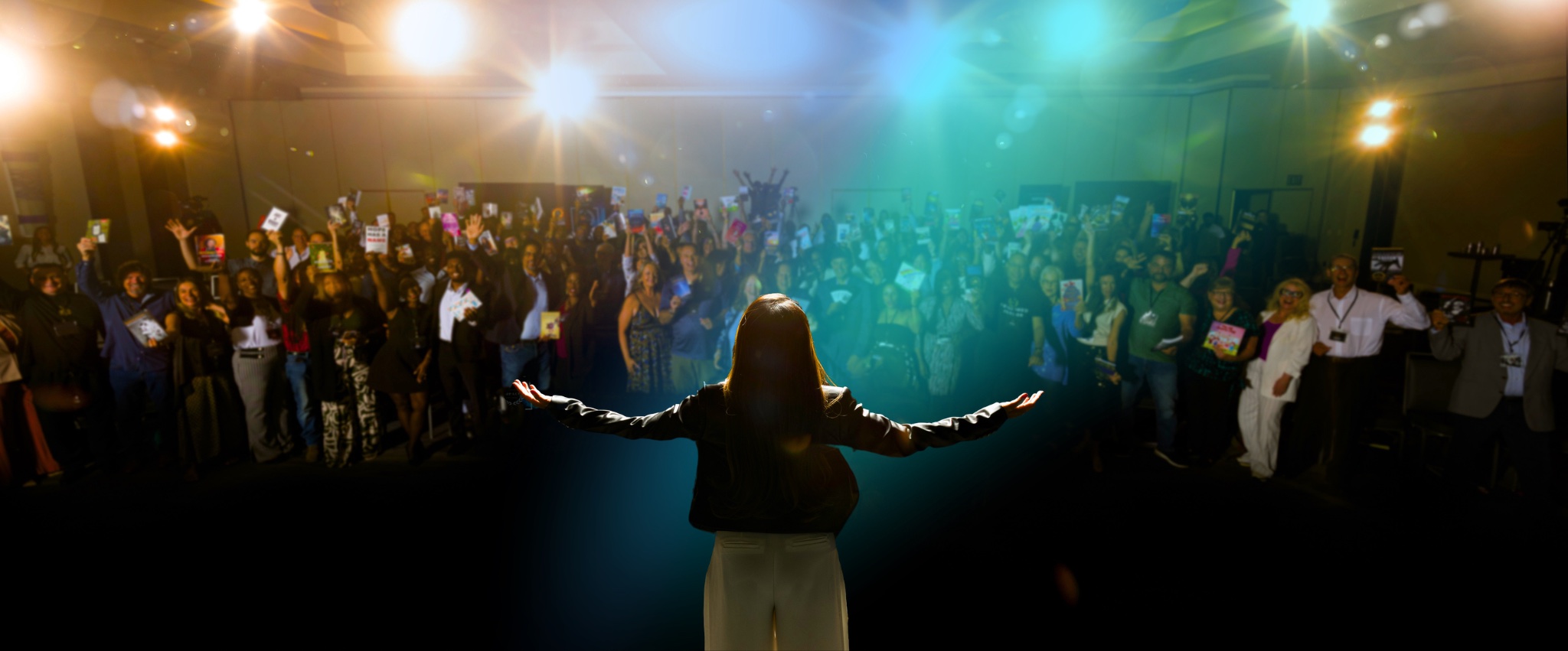 Nim Stant on stage before a full audience of authors